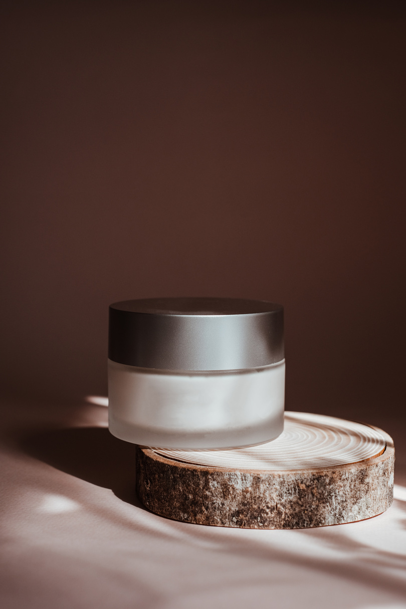 Cosmetic Product on Wooden Coaster